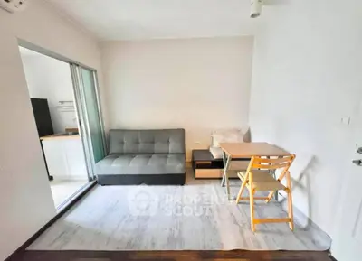 Cozy living room with modern sofa and dining area in compact apartment