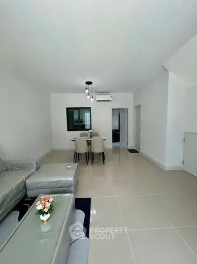 Modern living room with sleek furniture and neutral tones, perfect for relaxation and entertainment.