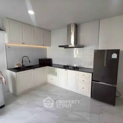 Modern kitchen with sleek cabinets and gas stove in a bright, spacious layout.