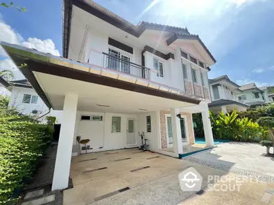 Charming two-story house with spacious driveway and lush garden in serene neighborhood.