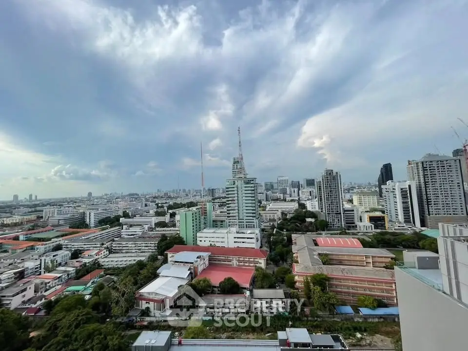 Stunning cityscape view from a high-rise building showcasing urban skyline and expansive sky.