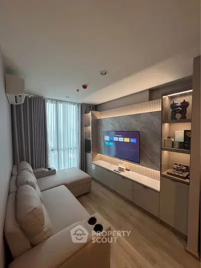 Modern living room with sleek entertainment center and cozy sectional sofa
