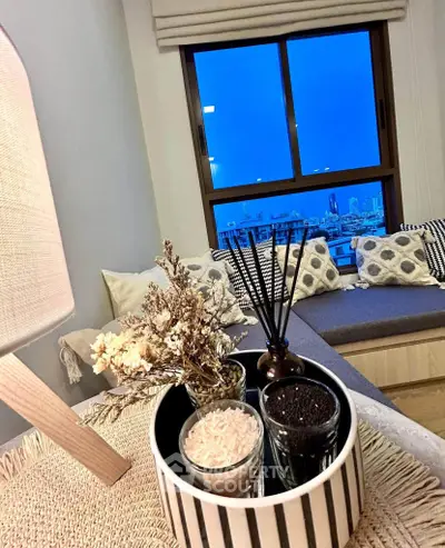Chic living room with cozy seating and stunning city view at dusk.