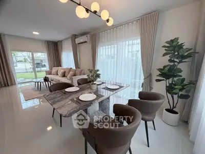 Elegant open-plan living and dining area with modern decor and natural light