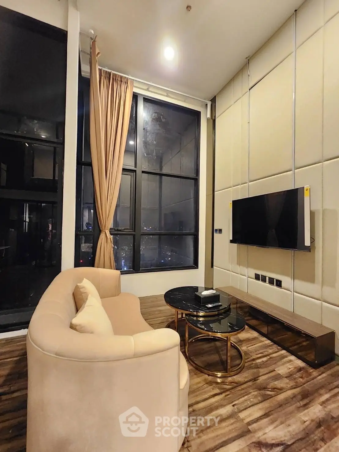 Luxurious modern living room with large windows and elegant furnishings