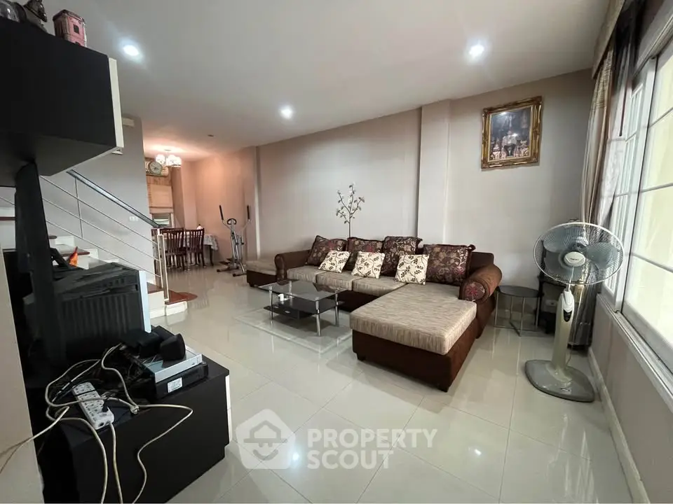 Spacious living room with elegant decor and large windows for natural light.