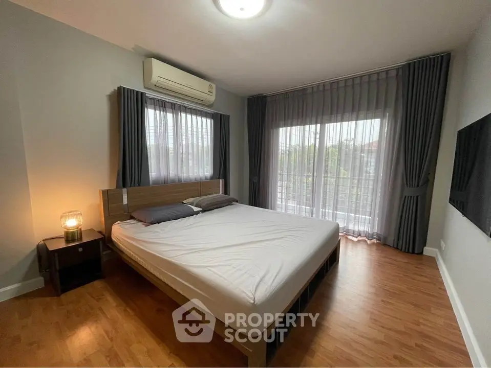 Spacious bedroom with large windows and modern decor