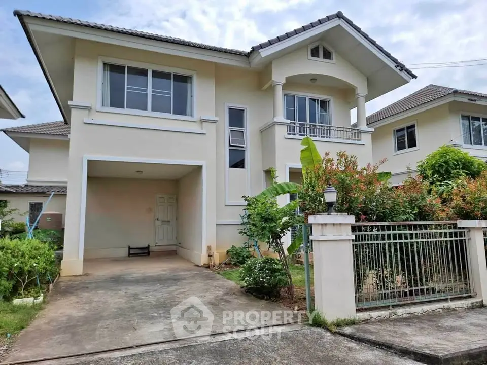 Charming two-story house with driveway and lush garden in a serene neighborhood.