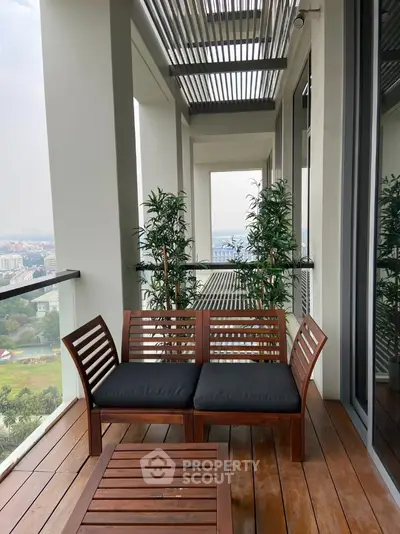 Spacious balcony with wooden seating and city view, perfect for relaxation and enjoying the outdoors.