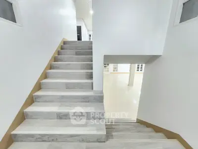 Modern staircase with sleek design in a bright, spacious interior