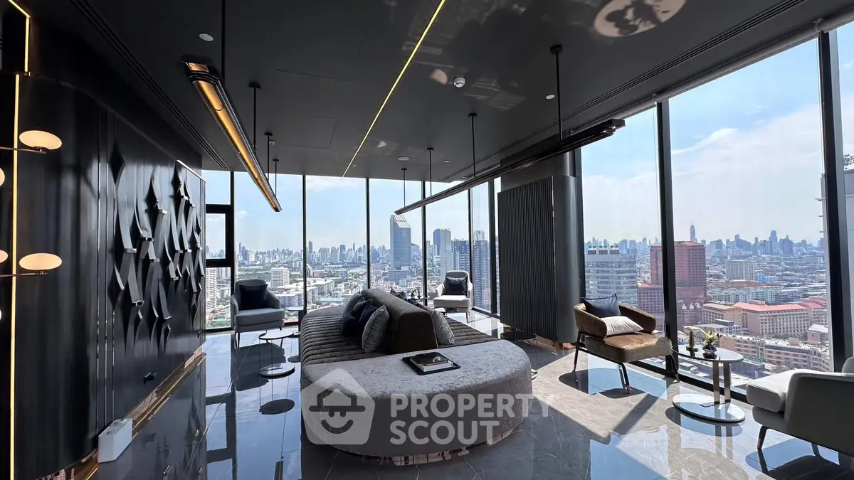 Luxurious high-rise living room with panoramic city views and modern decor.
