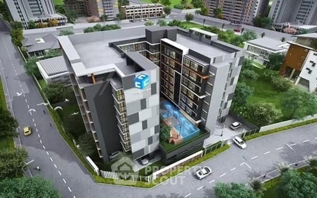 Aerial view of modern apartment complex with pool and landscaped surroundings.