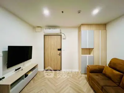 Modern living room with stylish furniture and wall-mounted TV in a cozy apartment.