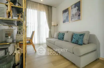 Modern living room with stylish decor and natural light, featuring a comfortable sofa and elegant artwork.
