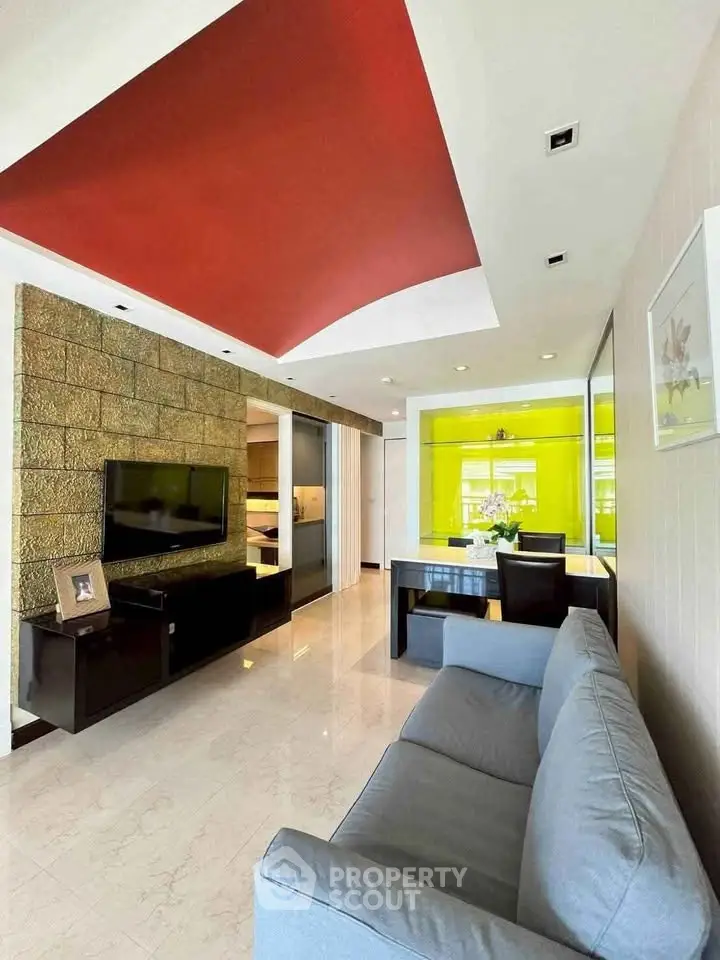 Modern living room with stylish red ceiling and sleek furniture
