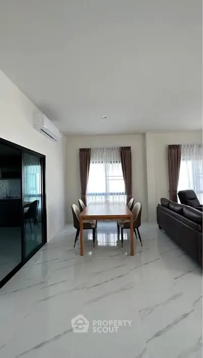 Spacious modern living room with dining area and large windows