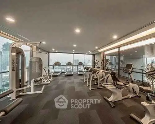 Modern gym with city view in luxury apartment building