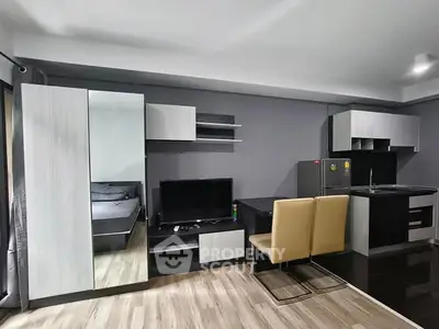 Modern studio apartment with sleek kitchen and cozy living area