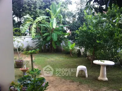 Charming garden view with lush greenery and outdoor seating, perfect for relaxation and nature lovers.