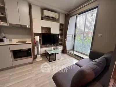 Modern living room with sleek furniture and balcony access, perfect for urban living.
