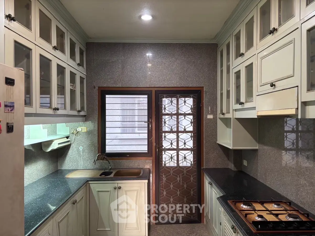 Spacious kitchen with gas stove and ample cabinetry in modern home