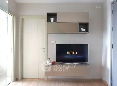 Modern living room with sleek TV setup and stylish storage units.