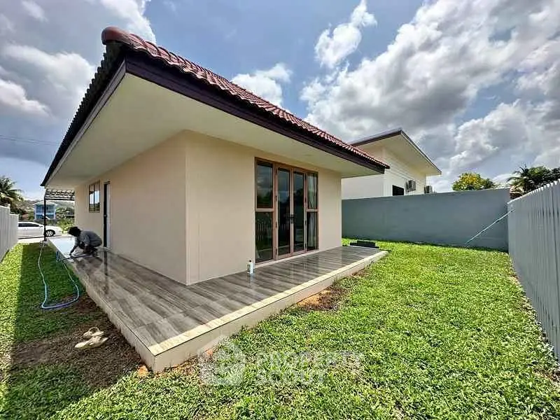 Charming single-story home with spacious backyard and modern patio, perfect for outdoor relaxation.