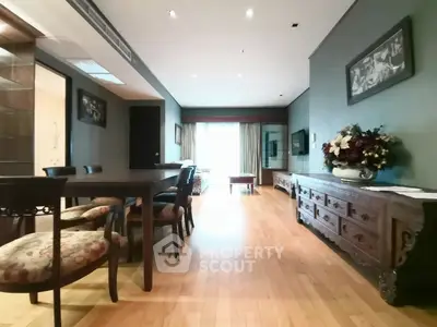 Spacious living room with elegant dining area and wooden flooring