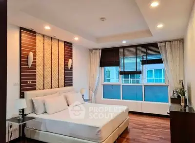 Spacious modern bedroom with elegant decor and large window view