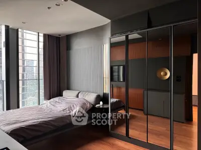 Luxurious modern bedroom with floor-to-ceiling windows and sleek mirrored wardrobe in urban high-rise.