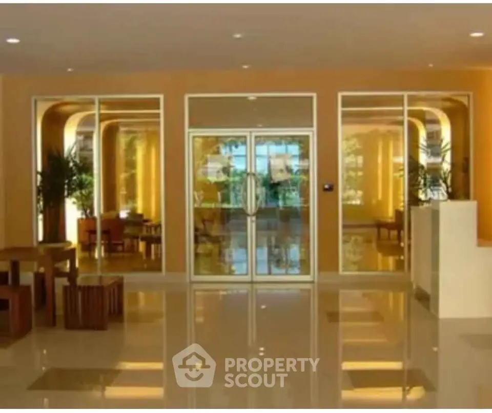 Elegant building entrance with glass doors and modern decor