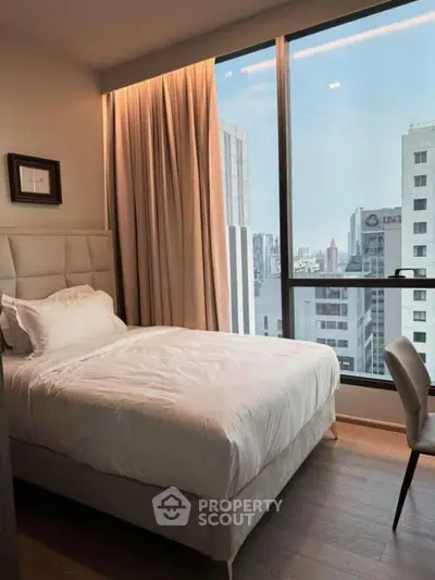 Modern bedroom with city view in high-rise apartment