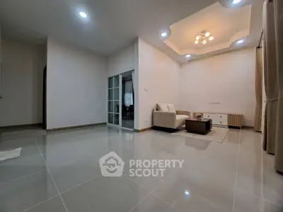 Spacious modern living room with elegant lighting and sleek tile flooring