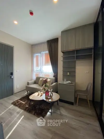 Modern living room with cozy seating and stylish decor in a contemporary apartment.