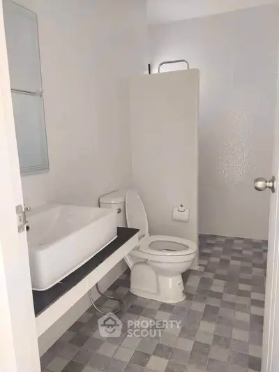 Modern bathroom with sleek design and contemporary fixtures in a real estate property.