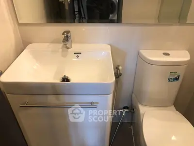 Modern bathroom with sleek sink and toilet in compact space