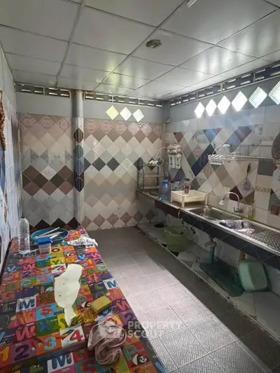 Spacious kitchen with colorful tiled walls and ample counter space