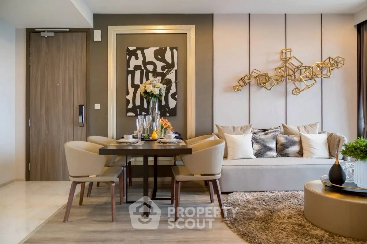 Modern living room with stylish decor and dining area, featuring elegant furniture and artistic wall accents.