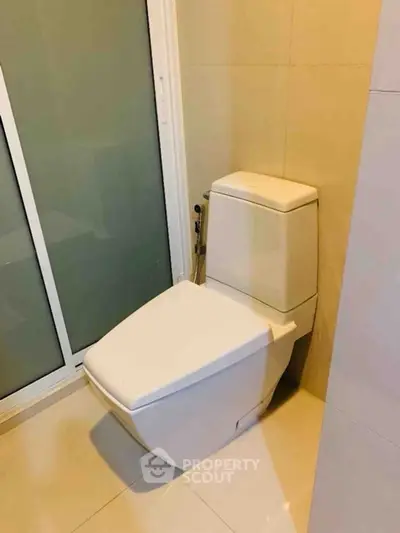 Modern bathroom with sleek toilet and glass shower door