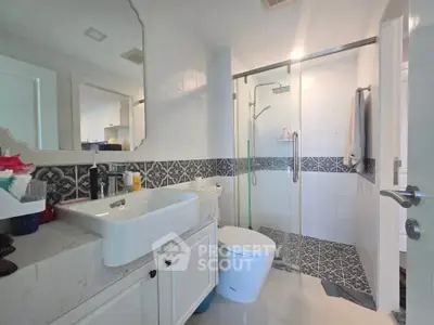 Modern bathroom with stylish tiles and glass shower enclosure