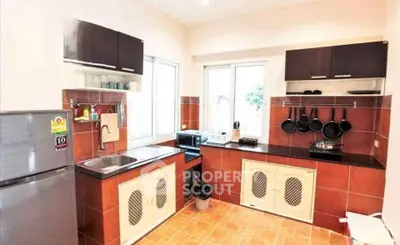 Charming kitchen with modern appliances and open layout, featuring sleek cabinets and ample natural light.