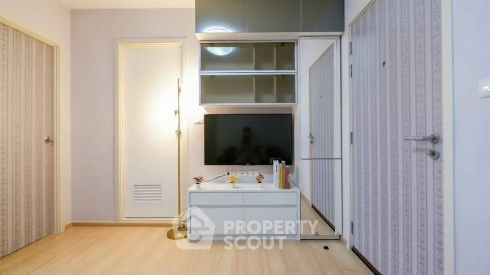 Modern living room with sleek storage and TV unit, featuring elegant lighting and stylish decor.