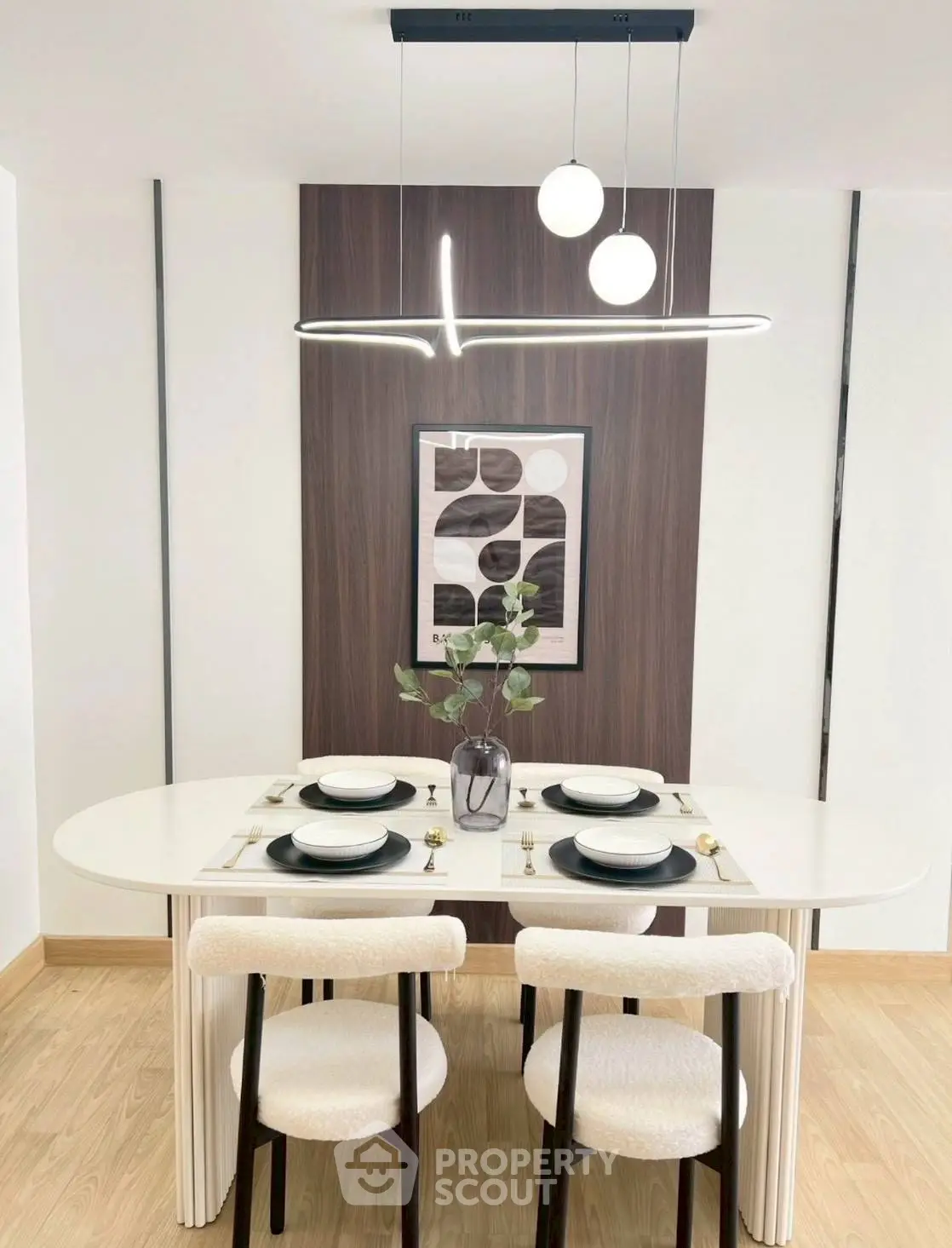 Modern dining area with elegant table setting and contemporary lighting in a stylish apartment.