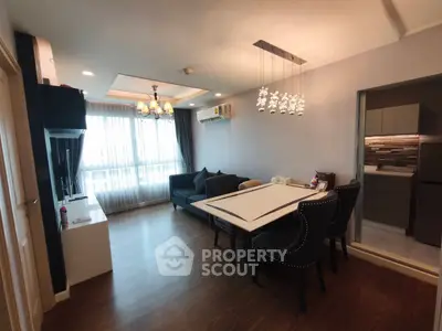 Spacious living room with elegant dining area and modern lighting in a stylish apartment.