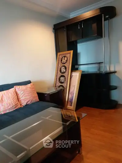 Cozy living room with modern furniture and decorative wall art, perfect for relaxation and entertaining.