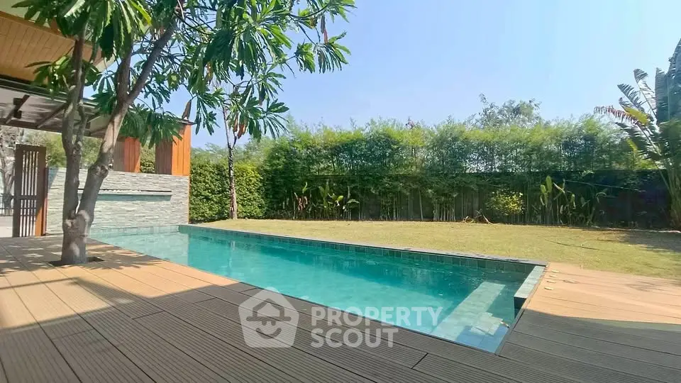 Luxurious backyard with private pool and lush greenery, perfect for relaxation and entertainment.