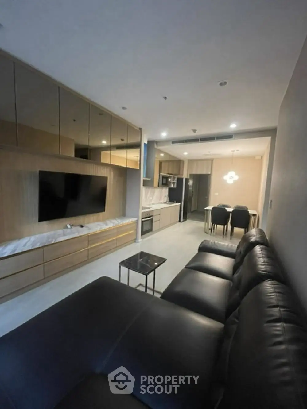 Modern living room with sleek furniture and open kitchen layout