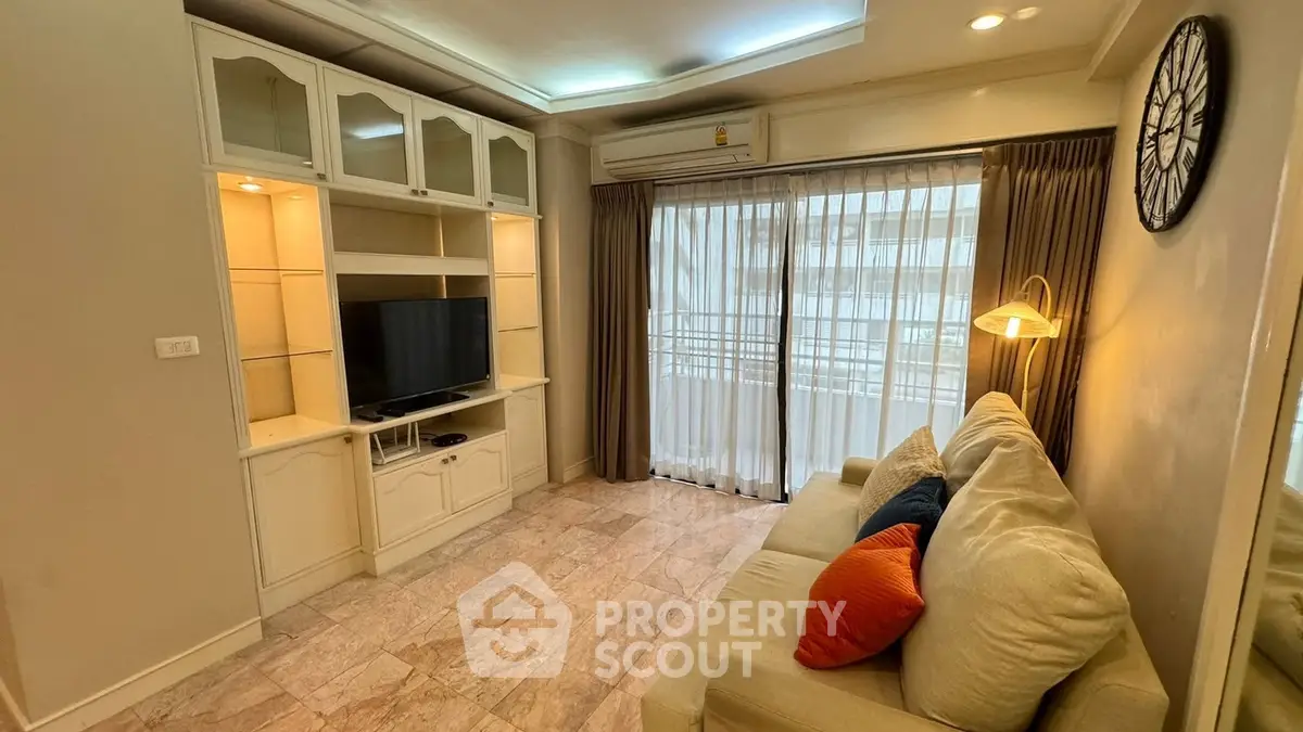Cozy living room with elegant decor and natural light from large window.