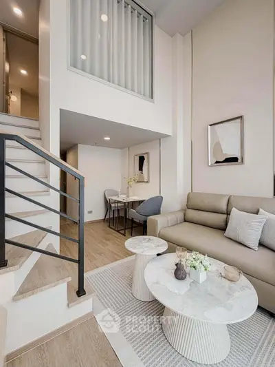 Modern duplex living room with stylish decor and elegant staircase