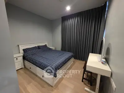 Cozy bedroom with modern furnishings and elegant curtains, perfect for relaxation and comfort.